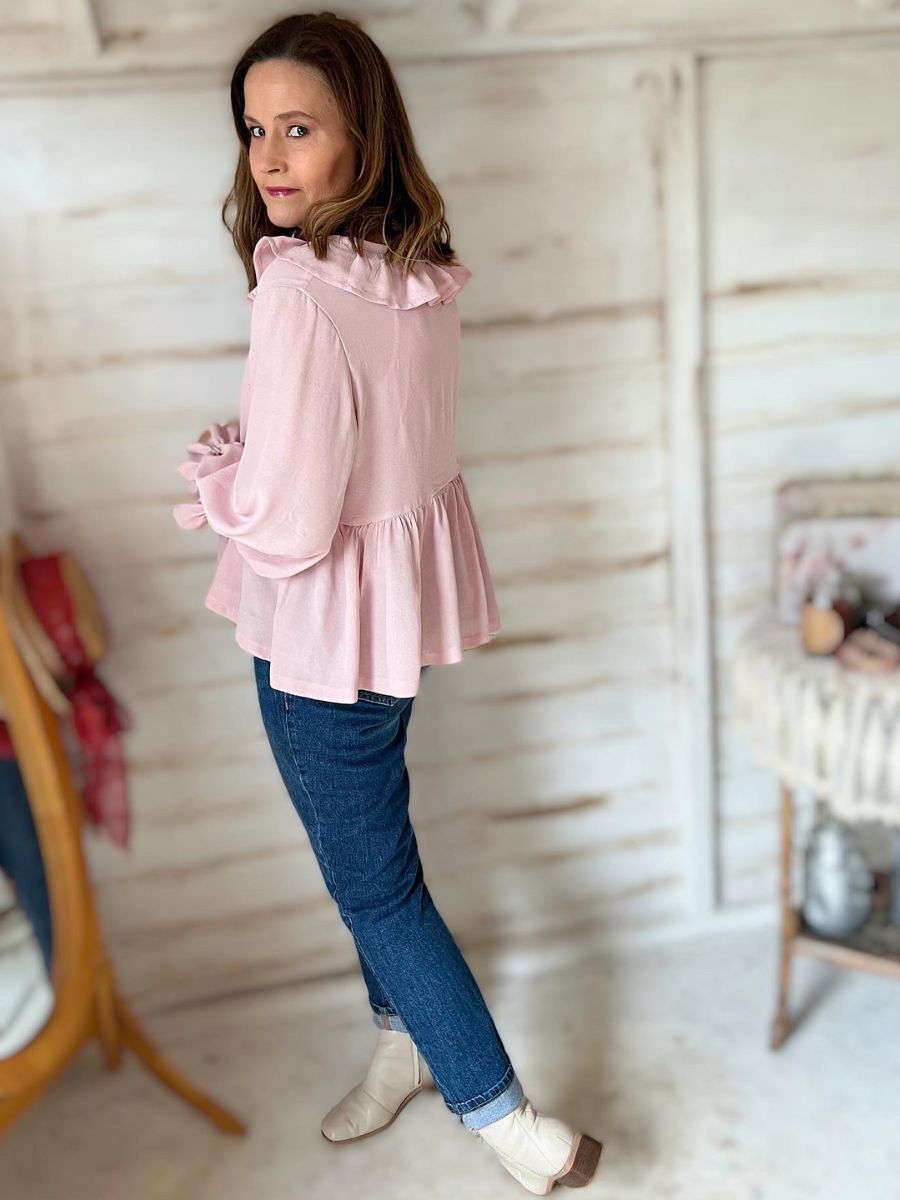 woman standing with pink Dixie blouse and jeans